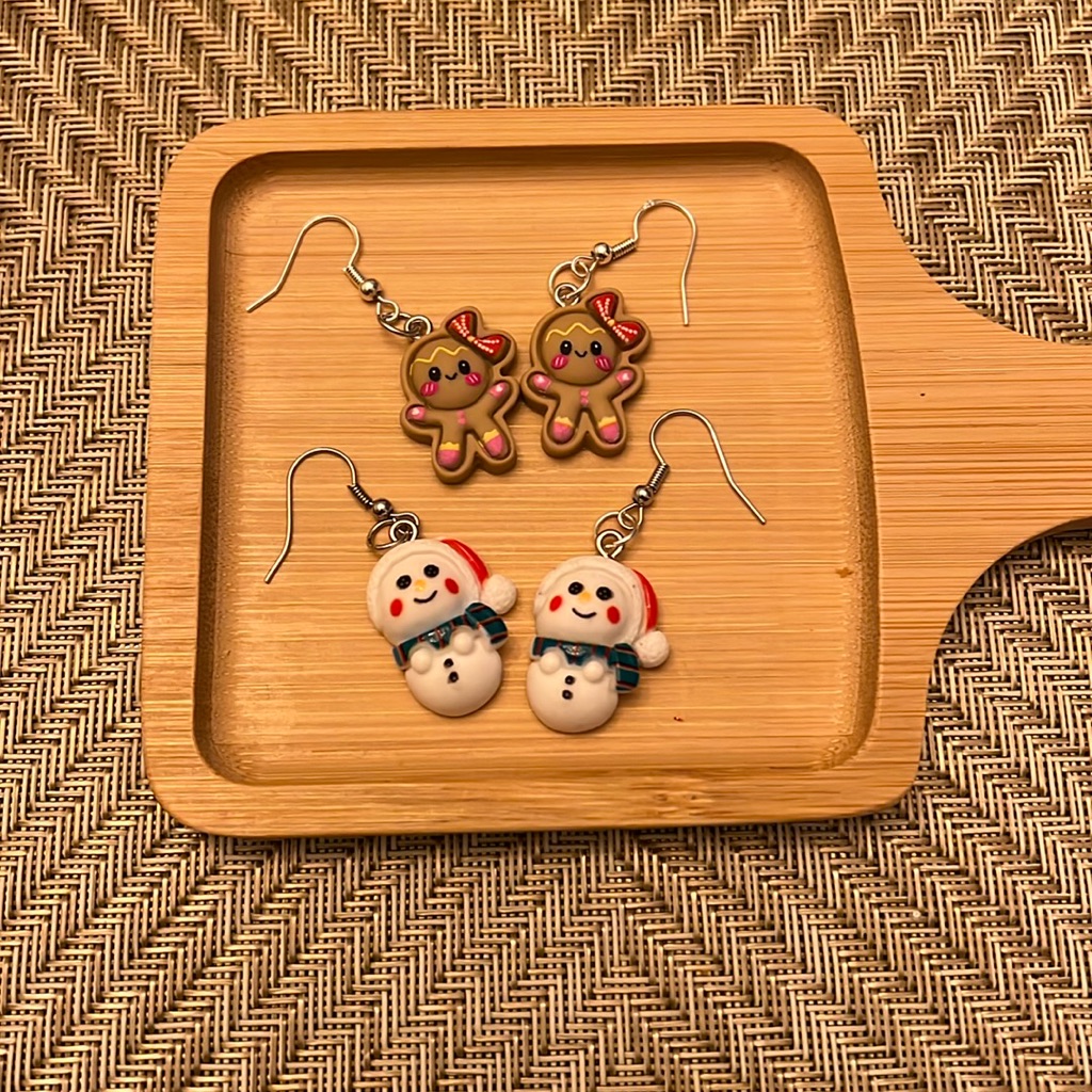 A Pair Of Christmas Gingerbread Girl And Snowman Earrings